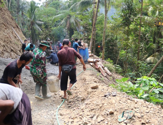 Pelda Ratam dan Warga Kompak Angkut Ember Gotong Royong Percepat Pengecoran TMMD