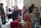 Babinsa Koramil 04/Karangkobar Bantu Bidan Desa Dampingi Giat Posyandu Balita