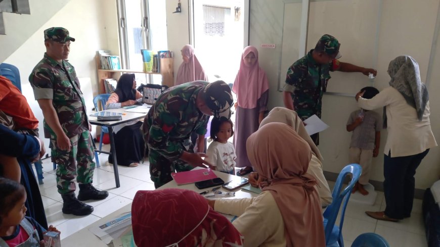 Babinsa Koramil 04/Karangkobar Bantu Bidan Desa Dampingi Giat Posyandu Balita